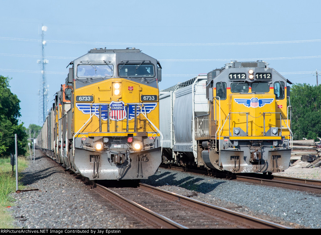 A rock train and a local wait to head west